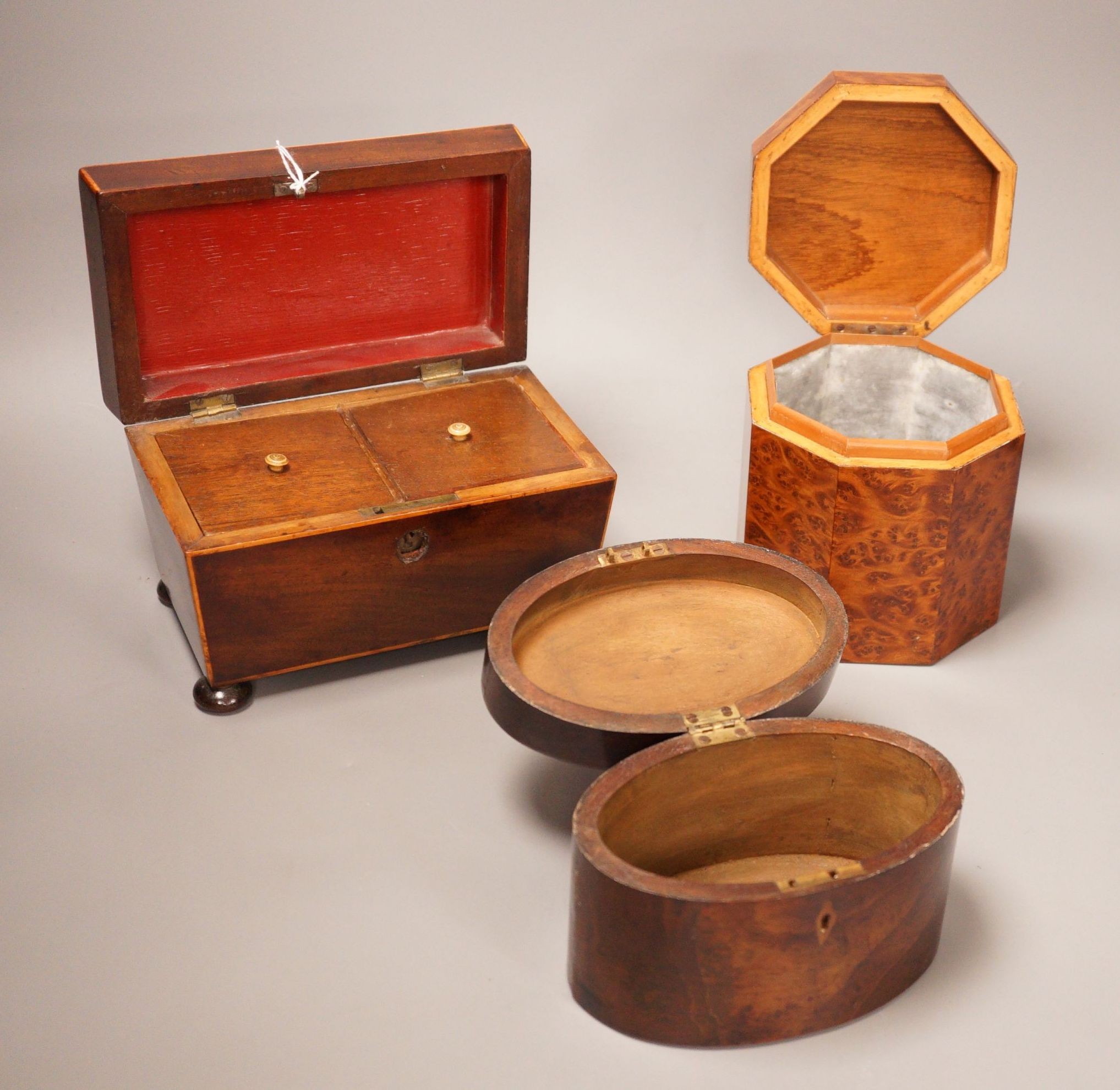 An oval mahogany box (with key), an octagonal amboyna tea caddy and a boxwood edged mahogany tea caddy, 19th century 20cm wide